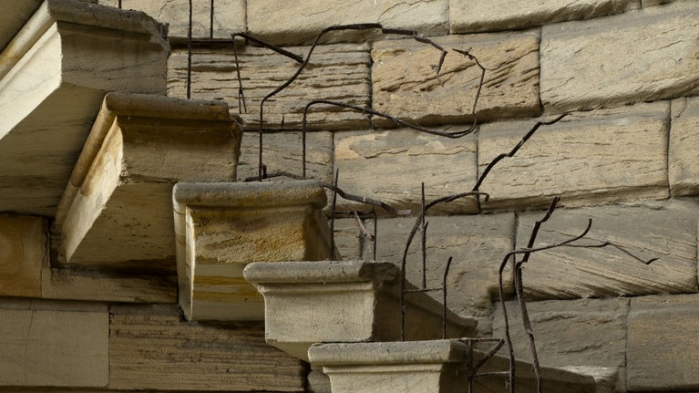 A close-up shot of the stone spiral staircase and fire-damaged banisters at Seaton Delaval Hall, Northumberland